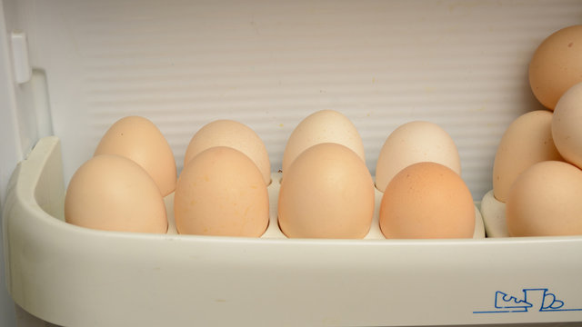 chicken eggs are in the door of the refrigerator tray