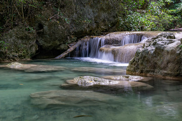 Clean green emerald water from the waterfall Surrounded by small trees - large trees,  green colour, Erawan waterfall, Kanchanaburi province, Thailand