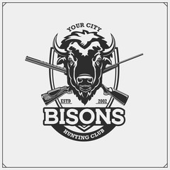 Hunting club emblem with bison and crossed rifles. © malashkos