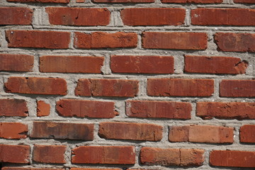 very old red brick wall of a rural house