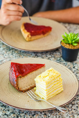 Vegan desserts: berry cake and cheesecake in restaurant.
