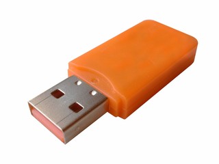 Orange plastic USB flash drive isolated on white