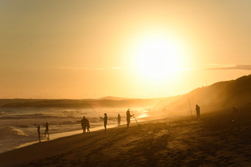 Fototapeta premium Family Fishing On A Sunset Afternoon Beach, Mossel Bay, South Africa