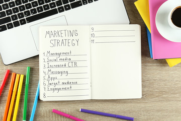 Digital marketing strategies concept. Hand written marketing plan. Close up, copy space, top view, flat lay, background.