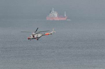 HELICOPTER AND SHIP - Naval search and rescue machine by the sea