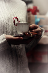 cup in hand and stack gifts