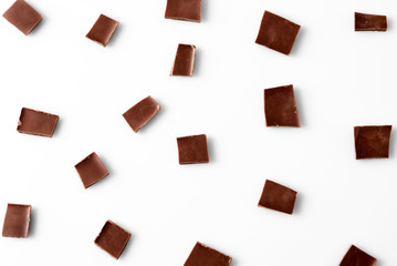 Chocolate slices on white background, top view