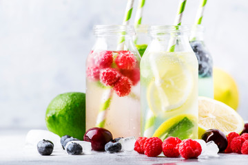 Summer drinks set. Berry, fruit and citrus non-alcoholic refreshing ice cold beverages and cocktails in glass bottles on white background