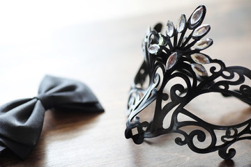 Black mask on the wooden background