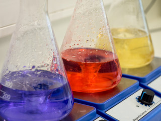 Erlenmeyer flasks with colorful solutions closeup