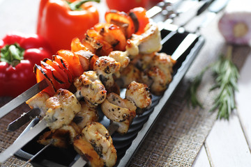 Kebab cooked on metal skewers with vegetables
