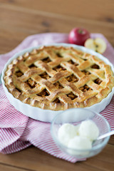food, culinary and baking concept - apple pie with ice cream on wooden table
