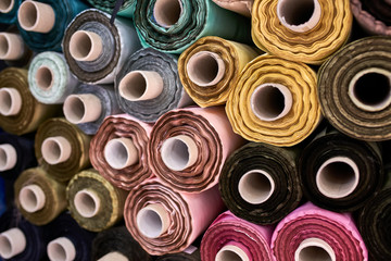 Fabric warehouse with many multicolored textile rolls - 277340809