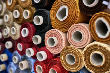 Fabric warehouse with many multicolored textile rolls - 277340835