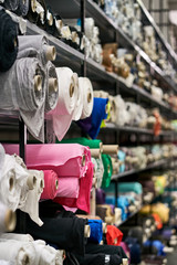 Fabric warehouse with many multicolored textile rolls