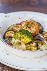 National Balkan food grilled vegetables in a white plate on the table in the restaurant.