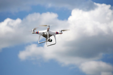White quadcopter with a video camera