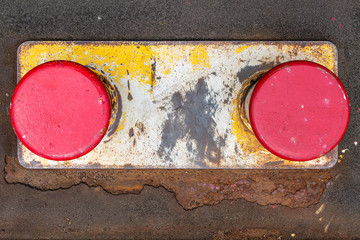 Rusty red and yellow bollard in Hamburg Harbor.