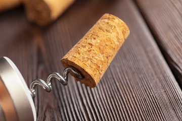 corkscrew for open wine cork bottle on wooden background