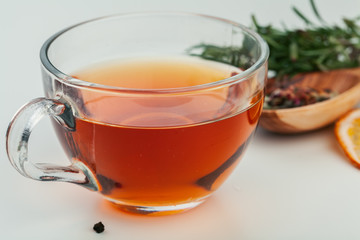 Dried tea heaped teaspoonful on white background, closeup