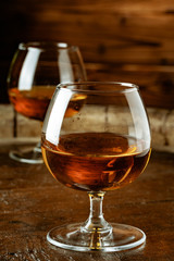 Two glasses of whiskey on a wooden table in the bar