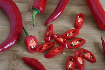 red hot peppers are large plan on a wooden board, chili peppers, autumn vegetables