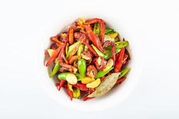 Delicious braised crayfish in a bowl on white background