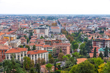 Fototapeta na wymiar Aerial view of Bergamo city, Lombardy, Italy. Central street Viale Roma and Bergamo Central Railway station in the end of the street on background