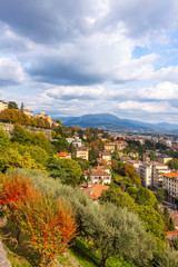 Fototapeta na wymiar Picturesque aerial view of Bergamo city, Lombardy, Italy. Bergamo Alps (Alpi Orobie) begin immediately north of the city, on the background