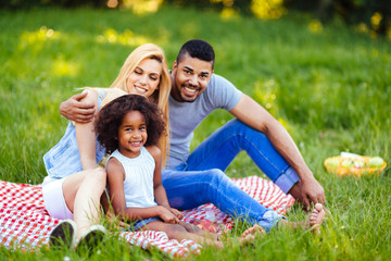 Fototapeta premium Picture of lovely couple with their daughter having picnic