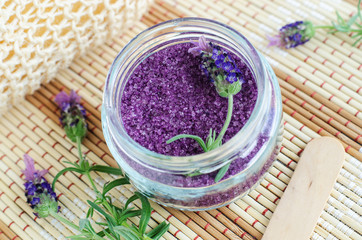 Homemade purple exfoliating scrub (foot soak, bath salt) with essential lavender oil. Lavender flower in the jar. Natural skin and hair care. DIY beauty treatments, spa recipe. Copy space. 