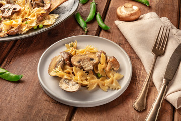Mushroom and cheese pasta. Farfalle with cremini and green peas, easy Italian vegetarian recipe