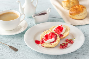 Classic scones with cream and berry jam