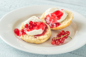 Classic scones with cream and berry jam