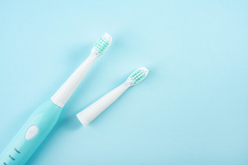 An electric toothbrush on a blue background