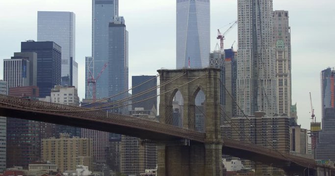 Close Up of The Famous Brooklyn Bridge With Cars Travelling on The Iconic Bridge With the Breathtaking New York Skyline And Infamous World Trade Centre in Slow Motion