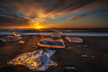 Diamond beach, South Iceland - February 27, 2019 : Sunrise at Diamond beach, near Jokulsarlon glacier lagoon - obrazy, fototapety, plakaty