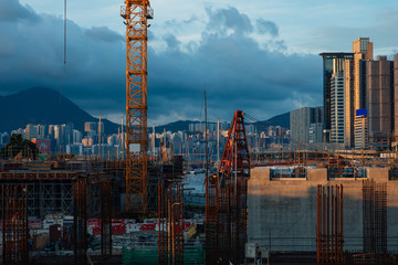 Construction site and skyline of Hong Kong in the sunset