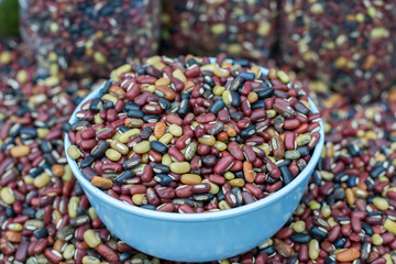 Multi-colored beans or Mixed dried beans in bowls for sale in Thailand.