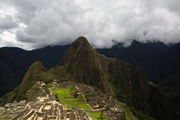 Machu Picchu city is illuminated by the sun through the clouds. city of the Incas. One of the New Seven Wonders of the World