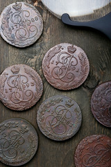 Numismatics. Old collectible coins made of copper on a old wooden table.