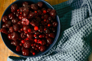 frozen cherries in the deep blue bowl crafted blue towel