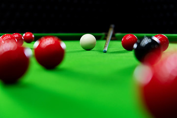 Snooker balls on the green table for playing entertainment of man.