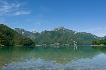Fototapeta na wymiar Beautiful view of mountain reflections in the water of Lago Di Ledro, Italy