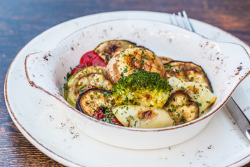 National Balkan food grilled vegetables in a white plate on the table in the restaurant.