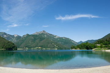 Fototapeta premium Lake Ledro with mountains reflecting in the water. Trento, Italy