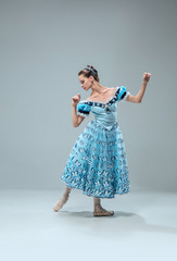 Naklejka premium Butterflies. Beautiful contemporary ballroom dancer isolated on grey studio background. Sensual proffessional artist dancing walz, tango, slowfox and quickstep. Flexible and weightless.