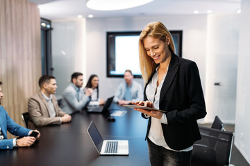Attractive businesswoman using digital tablet in office