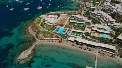 Obraz premium Aerial drone photo of paradise celebrity bay of Ornos famous for pool resorts and sandy turquoise organised clear sea beach, Mykonos island, Cyclades, Greece