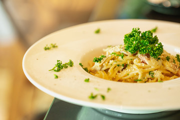 Carbonara pasta, spaghetti with pancetta, egg, hard parmesan cheese and cream sauce. Traditional italian cuisine. Creamy Italian pasta with mushrooms.